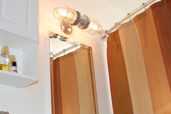 Where do wall sconces go in bathroom?