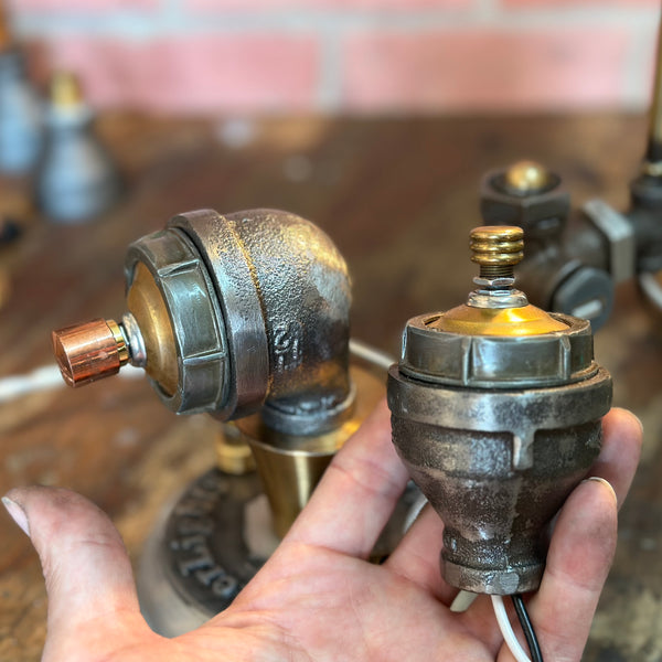 Close-up of Steampunk Pipe Lamp Dimmer Module showing industrial-style dimmer switch with exposed wiring and brass fittings on a rustic surface.