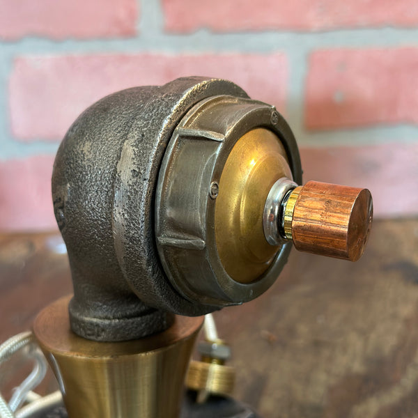 Side view of Steampunk Pipe Lamp Dimmer Module featuring copper dimmer knob and brass detailing against a brick wall background.