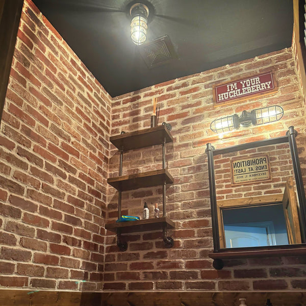 Small rustic bathroom light fixture on brick wall by MillerLights