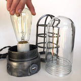 table lamp base with clear glass globe and metal cage guard