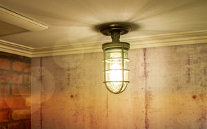 rustic industrial ceiling light with metal cage and wood base 