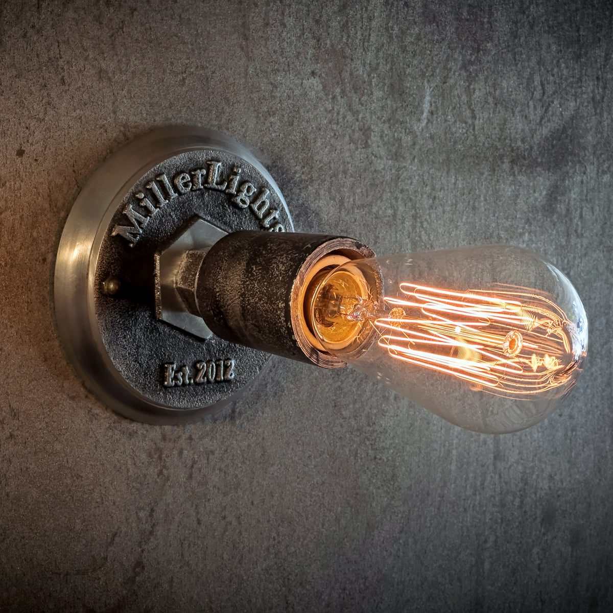 Rustic ceiling light with warm glowing Edison bulb.