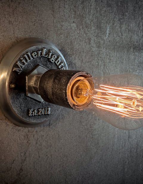 Rustic ceiling light with warm glowing Edison bulb.