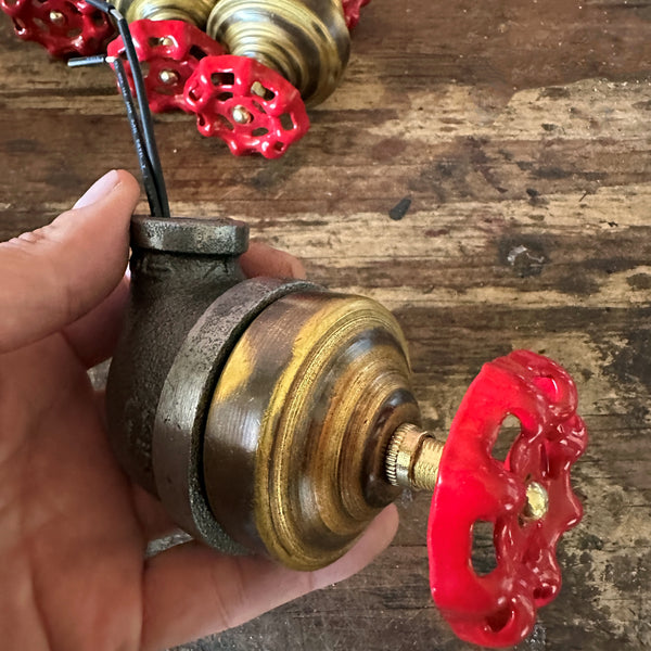 /2 inch industrial iron pipe lamp switch with a vintage red faucet handle on a raw metal finish.