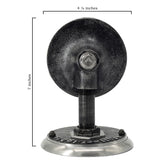 Extending from the wall mount, a short black metal arm supports the socket assembly, which has a weathered, industrial finish.