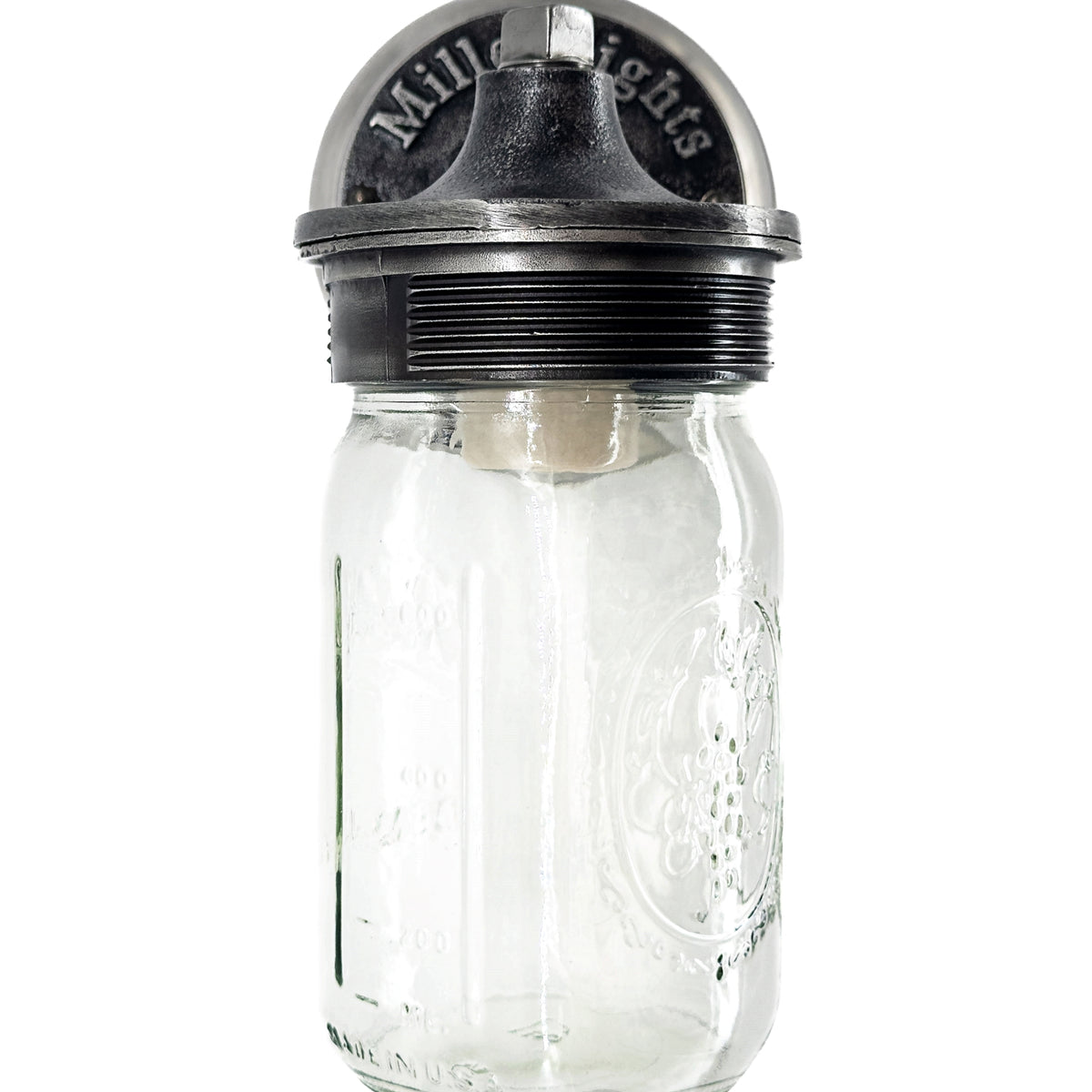 industrial sconce light, Instead of a traditional shade, the bulb is enclosed inside a clear glass mason jar, repurposed as the light cover. The jar has embossed markings and the classic “Ball” logo, adding vintage authenticity