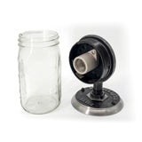 mason jar light features a vintage-style design with a clear glass jar, The metal components have a weathered, black finish, The base is engraved with 