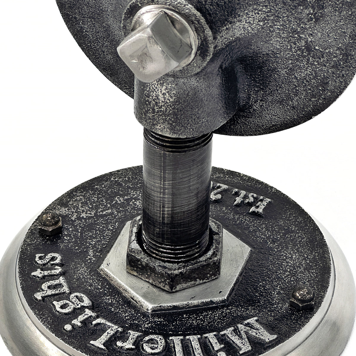 The base is engraved with "Miller Lights Est. 2012 and black pipe extending from the wall with a hanging mason jar as the lamp shade