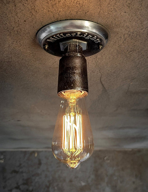 Industrial-style light with exposed filament bulb.