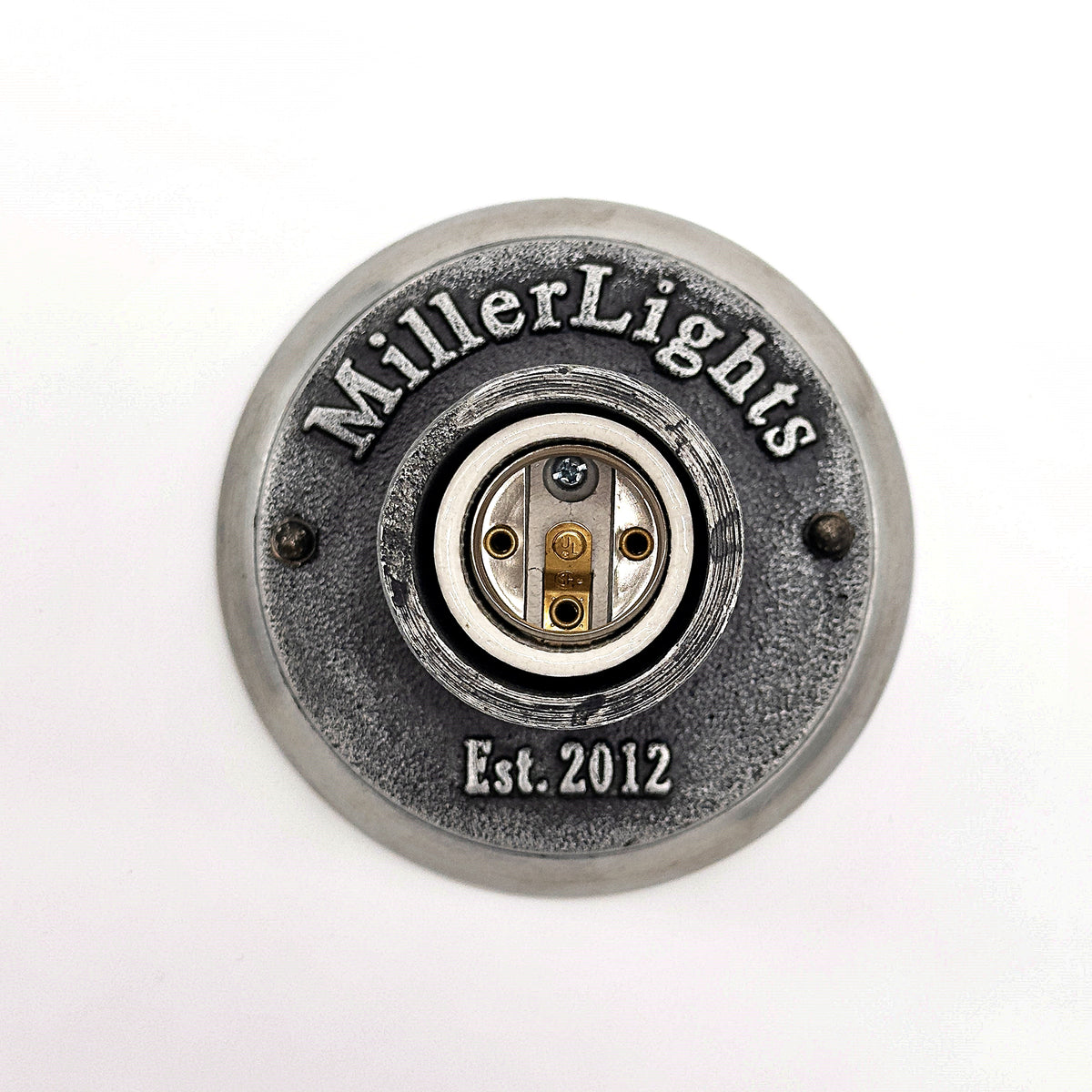 Classic Edison bulb hanging from a weathered ceiling fixture.
