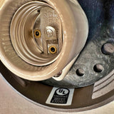 Close-up interior detail of MillerLights 'The Ward' wall sconce showing the durable porcelain E26 medium base socket alongside an official UL Certified safety compliance label for US and Canada.